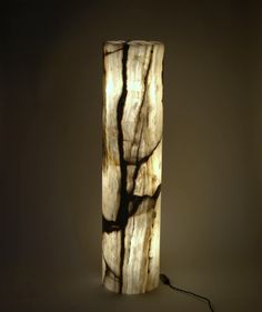 a lamp that is made out of wood and has black lines on the side of it