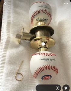 two baseballs and a fishing hook on a towel