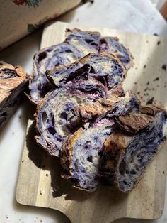 sliced up blueberry bread sitting on top of a cutting board