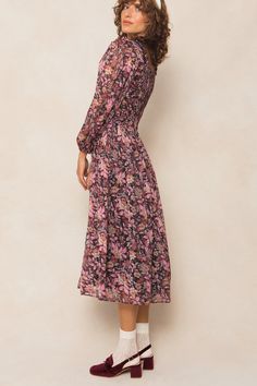 Searching for modest long sleeve dresses? Introducing our Sasha Dress - a playful and flowy addition to your wardrobe. Made with black chiffon fabric and adorned with purple florals, this midi-length women's dress features a square neckline with ruffle detailing, a hidden back zipper, smocking, and ruching. All of these unique details and more make this dress stand out. Perfect for fall and beyond. Flowy Purple Maxi Dress For Fall, Feminine Fall Chiffon Midi Dress, Purple Flowy Long Sleeve Midi Dress, Feminine Chiffon Midi Dress For Fall, Purple Long Sleeve Flowy Midi Dress, Purple Chiffon Midi Dress, Modest Long Sleeve Purple Dresses, Purple Floral Print Long Sleeve Midi Dress, Purple Long Sleeve Floral Print Midi Dress