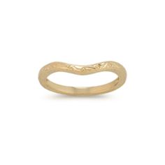 a gold wedding band with an intricate design