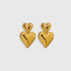 Elevate your style with the stunning Heart Statement Earrings from Biella Vintage. Crafted with exquisite attention to detail, these earrings feature a luxurious gold-plated finish that adds a touch of elegance to any outfit. The bold heart design makes a chic statement, perfect for both day and night wear. Whether you're dressing up for a special occasion or adding a glamorous touch to your everyday look, these earrings are the perfect accessory. Let your style shine with Biella Vintage. Material: High-quality 18k gold-plated Design: Bold heart shape Style: Statement, versatile Occasions: Perfect for any event or casual wear Enhance your jewelry collection with a piece that embodies timeless elegance and modern charm. Chic Heart Drop Earrings For Anniversary, Chic Heart Shaped Drop Earrings For Anniversary, Chic Anniversary Heart Drop Earrings, Gold Double Heart Earrings For Party, Heart Shaped Earrings For Formal Occasions, Gold Heart Pendant Earrings For Party, Gold Double Heart Earrings For Formal Occasions, Chic Earrings For Anniversary On Valentine's Day, Heart-shaped Earrings For Formal Occasions