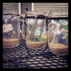 three jars with pictures in them sitting on a table