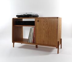 a record player is sitting on top of a cabinet