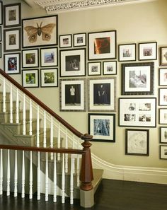 a staircase with many framed pictures on the wall