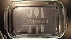 a glass dish with the words baffisti written on it and forks and spoons