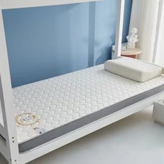 a white bunk bed sitting in a bedroom next to a window