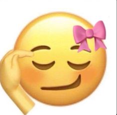 a yellow emoticure with a pink bow on it's head