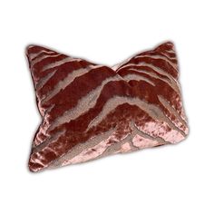 a brown and pink zebra print pillow on a white background