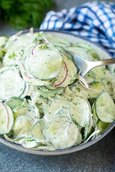 a bowl filled with cucumber salad on top of a table