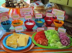 a table topped with lots of food and plates filled with different types of foods on it