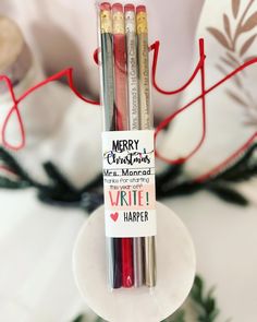 three pens sitting on top of each other in front of a christmas ornament