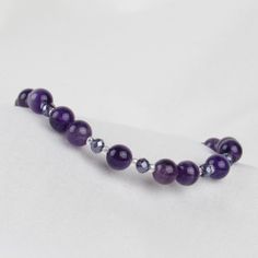 This beaded bracelet showcases smooth and shiny amethyst beads and tiny purple crystals. A perfect combo for those who love simple and elegant styles! ABOUT: * Materials: sterling sliver lobster claw and sterling silver 1.5 inch extension * Beads: amethyst gemstone, glass beads * Width: 6mm SHOP OUR BRAND > https://rosaperlina.etsy.com WHAT IS STERLING SILVER? * Sterling silver is a mix of 92.5% of silver and 7.5% of other metals, typically copper. * The added copper gives sterling silver a grea Adjustable Amethyst Stretch Bracelet In Purple, Adjustable Purple Amethyst Stretch Bracelet, Purple Amethyst Stretch Bracelet With Round Beads, Purple Amethyst Beaded Bracelets For Healing, Faceted Purple Amethyst Beaded Bracelets, Purple Amethyst Faceted Beaded Bracelets, Amethyst Gemstone Beaded Bracelets, Purple Faceted Amethyst Beaded Bracelets, Purple Amethyst Beaded Bracelets As Gift