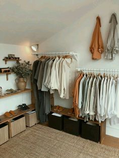 an organized closet with clothes and shoes hanging on the wall, baskets under it and shelves below