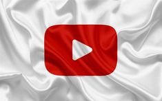 a white and red flag with a play button on it's left side in the center