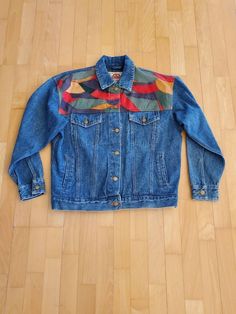 "Brand Blue Creek Jeans Amazing multicolored patchwork  denim trucker's jacket women's size medium (fits like a large) unisex size m/l (buttons on left so it's a women's but it's big for a medium oversized room fit) Nice condition has hand and chest pocket 80's or 90's vintage  Measurements: 21\" shoulder to shoulder 23\" sleeve 23\" pit to pit 46\" chest 40\" around waist at bottom hem adjustable  to be made smaller with button 26\" full length" Oversized 90s Denim Jacket For Fall, 90s Oversized Denim Jacket For Fall, Multicolor Denim Jacket For Fall, Fall Multicolor Denim Jacket, Retro Denim Patchwork Outerwear, Retro Relaxed Fit Denim Jacket For Fall, Retro Patchwork Denim Jacket For Fall, Retro Patchwork Denim Jacket For Winter, Retro Winter Denim Jacket With Patchwork