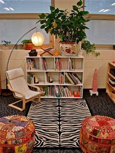 a living room filled with lots of furniture and bookshelves next to a window