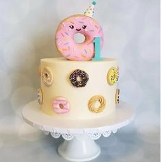 a birthday cake decorated with donuts and sprinkles