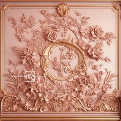 an ornate gold frame with flowers and leaves on the wall above it is a pink background