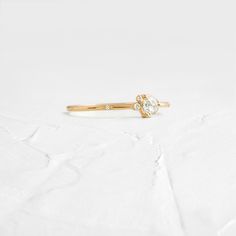 4mm rose cut white diamond (SI clarity) SI clarity white diamonds (1mm -1.5mm) Solid 14k gold setting with a delicate 1.2mm round band (available in yellow, rose, or white gold) Total carat weight: .18ct. We handcraft each piece with responsibly sourced 14k gold and ethically sourced stones. Everyday Stackable Rose Cut Diamond Rings, Dainty Diamond White Stackable Rings With Single Cut Diamonds, Delicate White Gold Diamond Ring With Single Cut Diamonds, Diamond White Stackable Rings With Rose Cut, Everyday Yellow Gold Diamond Ring With Rose Cut, Minimalist Rings With Single Cut Lab Grown Diamonds, Dainty Round Band Diamond Ring With Single Cut Diamonds, Delicate Diamond White Stackable Rings With Single Diamond, White Dainty Diamond Ring With Rose Cut