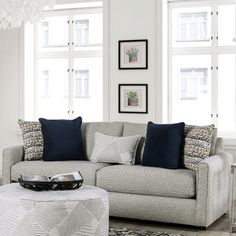 a living room filled with furniture and windows