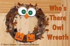 an owl wreath with two buttons on the front and one in the middle that says who's there?