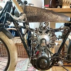 an antique motor bike is on display in a room with wicker baskets and other items