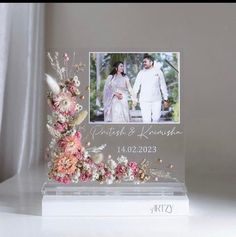 an acrylic photo frame with flowers on it