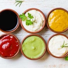 six small bowls filled with different types of sauces