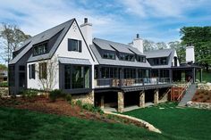 a large white house sitting on top of a lush green field