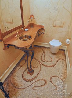 a bathroom with a sink, mirror and toilet paper roll on the floor next to it