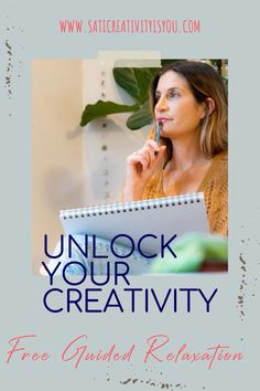 a woman holding a pen in her mouth while looking at a book with the title unlock your creativity