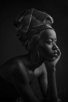 a black and white photo of a woman in a turban