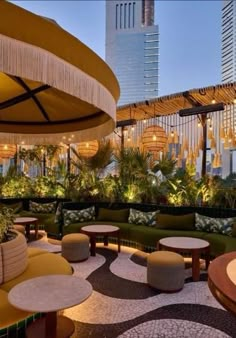 an outdoor seating area with tables and umbrellas