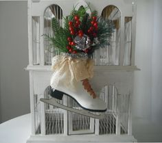 a white doll house with a christmas decoration on top of it's shoe and birdcage