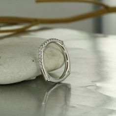 a diamond ring sitting on top of a rock