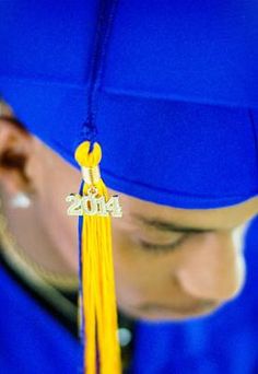 a person wearing a blue graduation cap and tassel