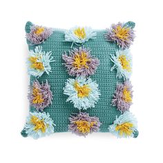 a crocheted pillow with flowers on it