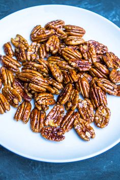 a white plate topped with lots of pecans