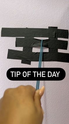 someone is painting the wall with black strips and white text that says tip of the day