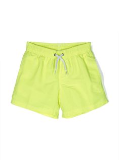 lemon yellow tonal stitching elasticated drawstring waistband two side slit pockets thigh-length Be mindful to try on swimwear over your own garments. Dress With Jean Jacket, Baby Boy Accessories, Dolce And Gabbana Kids, Burberry Kids, Stella Mccartney Kids, Lemon Yellow, Short Jumpsuit, Skirted Swimwear, Swimwear Tops