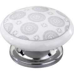 a white knob with an intricate design on it