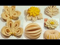 there are many different types of cookies on the table with flowers and leaves in them