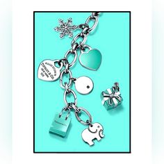 an elephant and heart shaped charms are attached to a chain with snowflakes in the background