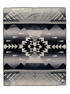 a black and white blanket with an abstract design