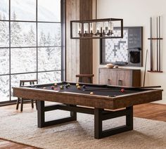 a pool table in front of a large window