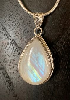 This fiery moonstone box pendant is absolutely stunning! Himalayan moonstone is very iridescent, glowing from many sides of the stone. Write a wish on a paper scroll, place inside, moonstone opens the crown chakra connecting to a higher feminine realm, relaying your wishes and prayers to be answered by the heavenly realm. Handmade, fair trade, sterling silver. 1.25”L x 0.75W Spiritual Moonstone Teardrop Pendant Jewelry, Spiritual Teardrop Moonstone Jewelry, Mystical Teardrop Jewelry For Gifts, Heavenly Realm, Paper Scroll, Handmade Fair, Crown Chakra, Himalayan, The Crown