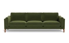 a green couch sitting on top of a white floor