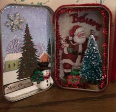 two tins that have christmas decorations in them