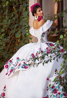 Dance the night away in this floral charro off the shoulder ball gown with A-line split front skirt by Ragazza Fashion M41-141. This beautiful long off the shoulder dress features an illusion V-neck bodice adorned with sequined and beaded floral appliques, short sleeves, open lace-up corset back, and a floor length A-line skirt with a sweep train. Floral Charro Off Shoulder Quinceanera Dress by Ragazza M41-141 Designer: Jazmín Collection by Ragazza Fashion 2023 Style Number: M41-141 Colors: Ivor White Charro Quinceanera Dresses, Charro Dress, Quinceanera Dresses Mexican, Split Front Skirt, Vestido Charro, Xv Dresses, Quinceanera Themes Dresses, Charro Quinceanera Dresses